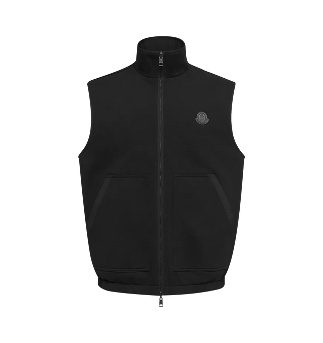 Image 1 of 1 - BLACK - Moncler Men's Reversible Zip-Up Vest combines contrasting textures with a versatile two-in-one construction, featuring soft cotton fleece on one side and smooth polyester on the reverse. Cut in a regular fit, this designer vest is finished with a zip-front closure, side pockets, and double leather Moncler logo patches, offering an adaptable layering piece for transitional weather. Base Fabric: 100% Cotton. Collar: 100% Cotton. Lining: 100% Polyester. Collar Lining: 100% Polyester. Det 
