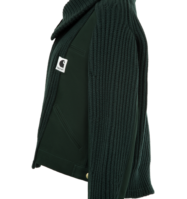 Image 3 of 4 - GREEN - Sacai x Carhartt WIP Women's Duck x Wool Knit Blouson is a hybrid of Carhartt WIPs Detroit Jacket and sacais knit blouson. Featuring two front layers on the body and sleeves, made from Carhartt WIPs duck canvas fabric, with rib-knit, spun wool and nylon yarn, an asymmetric front opening with a double zipper, and a high neck that can be worn up or down to form a flat collar, and co-branded woven label. A co-branded woven label appears on the front. Organic cotton canvas, Knit material  