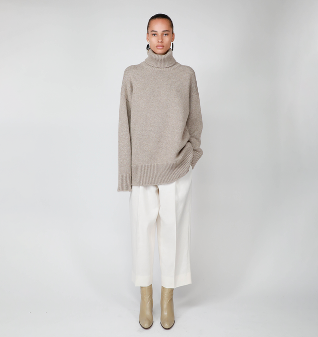 Image 3 of 3 - NEUTRAL - THE ROW Feries Turtleneck featuring oversized turtleneck in softly brushed cashmere with dropped shoulder and ribbed neckline, cuffs and hem. 100% cashmere. Made in Italy. 