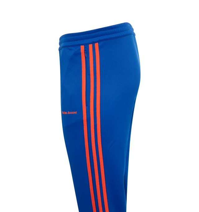 Image 3 of 3 - BLUE - ADIDAS X WALES BONNER Stirrup Track Pants featuring elastic waistband, stirrup cuffs at hem and logo details. 39% cotton, 61% recycled polyester. 