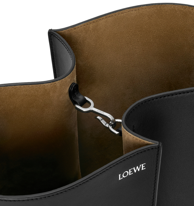 Image 4 of 5 - BLACK - LOEWE Medium Bilbao Bucket Bag in smooth calfskin featuring a trapeze shape bucket bag with a minimalist and graphic design, shoulder or crossbody carry, adjustable strap, detachable double L-embossed leather bell with concealed functional bottle opener, additional external d-ring for personalisation, hook closure to secure belongings, suede lining and embossed LOEWE. Smooth calf. 24 cm x 13 cm x 25 cm. Made in Spain. 