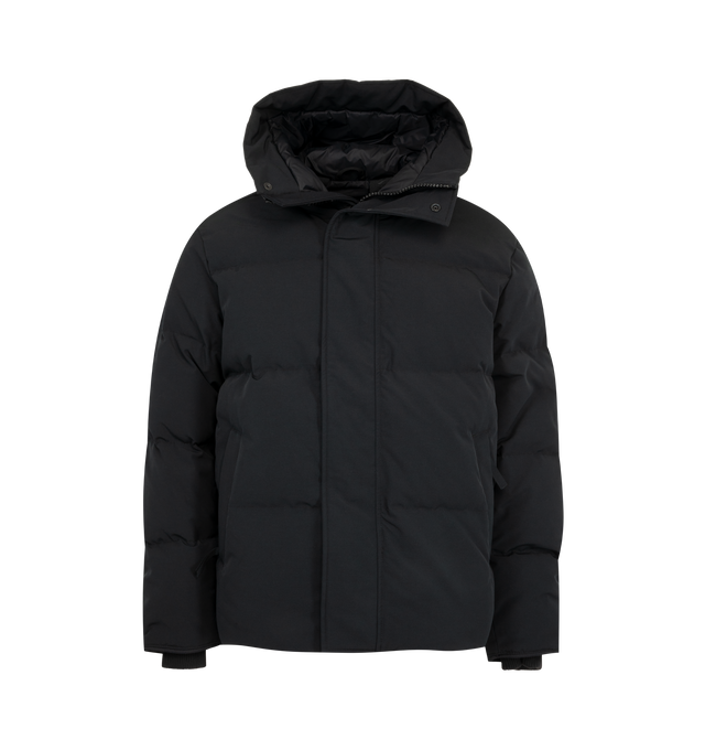 Image 1 of 4 - BLACK - Canada Goose Men's Seymour Parka is crafted from Recycled Organic Arctic Tech and features a quilt-through construction designed for protection in extreme cold-weather conditions. The parka is equipped with an adjustable snorkel hood, a tricot-lined chin guard, and a concealed snap placket over a front zip closure for enhanced coverage. Functional details include interior backpack straps for hands-free carrying, recessed rib-knit cuffs reinforced with CORDURA, two exterior zip pockets 