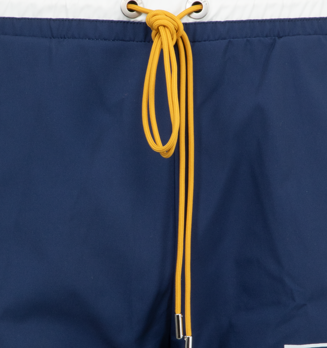 Image 4 of 4 - BLUE - Rhude Logo Basketball Swim Trunks have an elastic drawstring waist, side pockets, and a back pocket. 100% nylon.  