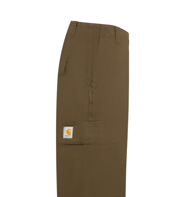 Image 3 of 3 - BROWN - Carhartt WIP Mens Kade Cargo Pants are crafted from midweight Columbia ripstop cotton. Feature a relaxed straight fit with a regular waist, button closure, adjustable waistband and leg openings, cargo pockets, side pockets, back flap pockets, bartack stitching at stress points, zip fly, and woven Square Label. Main Material: 100% Cotton Ripstop. Made in Tunisia. 