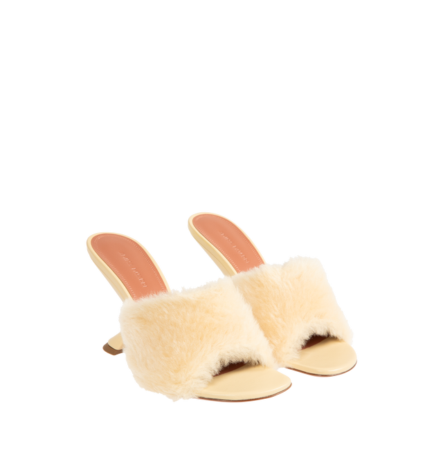 Image 2 of 4 - NEUTRAL - AMINA MUADDI Taylor Fur Slippers 90 featuring 90mm slanted heel, rounded open toe, beige fur strap and slip on style. Upper: 100% lamb leather. Lining: 100% goatskin. Sole: 90% calfskin, 10% TPU. Made in Italy. 