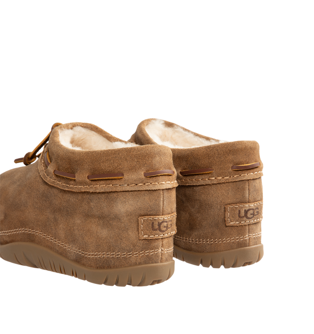 Image 3 of 4 - BROWN - UGG women's bucked clog made in soft suede with an elevated, worn-in feel and a leather whipstitch detail, signature sheepskin lining and cushy rubber platform sole. Features sugarcane EVA midsole, molded rubber outsole, woven label with UGG Logo on insole and UGG Logo embossed suede heel label. 