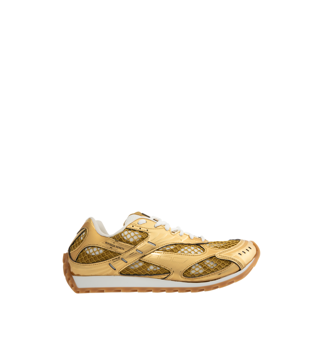 Image 1 of 5 - GOLD - BOTTEGA VENETA Sneakers featuring mechanical textile upper, rubber sole, lace-up front, padded collar and tongue with Bottega Venneta logo detail at tongue. Made in Italy. 