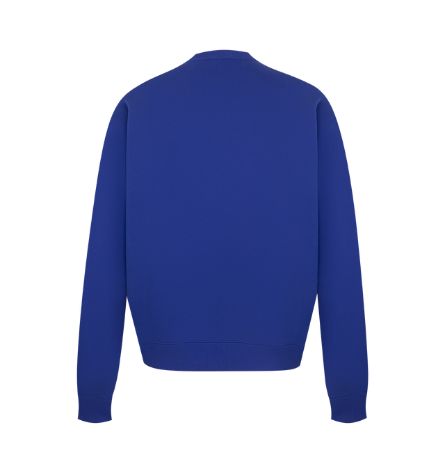 Image 2 of 3 - BLUE - Jil Sander Men's Cotton Terry Crew-Neck Sweatshirt is crafted from lightweight cotton terry and features a relaxed-fit silhouette with slightly dropped shoulders. Designed with a ribbed crew neck, hem and cuffs, and a vertical printed Jil Sander logo that reflects the brand's clean, modern aesthetic. Main Material: 100% Cotton. Made in Italy. 