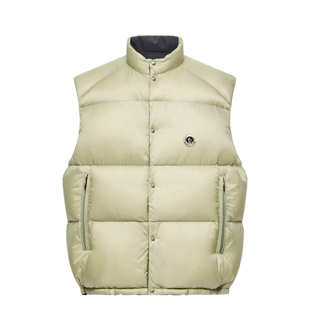 Image 1 of 2 - GREEN - Moncler Men's Tibb Reversible Down Vest is crafted from water-repellent longue saison nylon and features a reversible oversized silhouette with a wool reverse side. A modern evolution of a Moncler icon, this down-filled vest is designed with a stand collar, snap-button front closure, zipped pockets, and a drawstring hem for an adjustable fit. Finished with a vintage-inspired metal logo, the versatile style transitions easily between layering options and changing conditions. Main Mater 