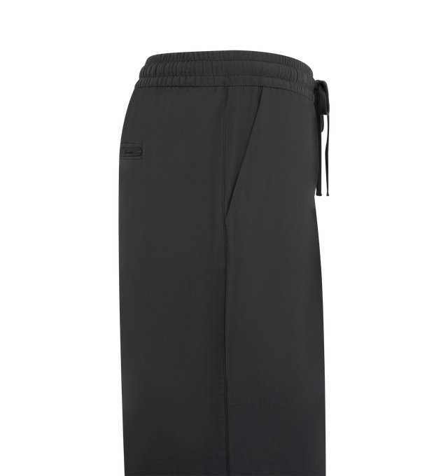 Image 3 of 3 - BLACK - Fear of God Essentials Mens Pleat Front Drawstring Pants are crafted from cotton canvas. Feature a relaxed fit with a relaxed leg and seat, front pleats, elasticized waistband with heavyweight drawstring, side-seam pockets, back welt pockets, and an Essentials signature label. Main Material: 100% Cotton Canvas. 