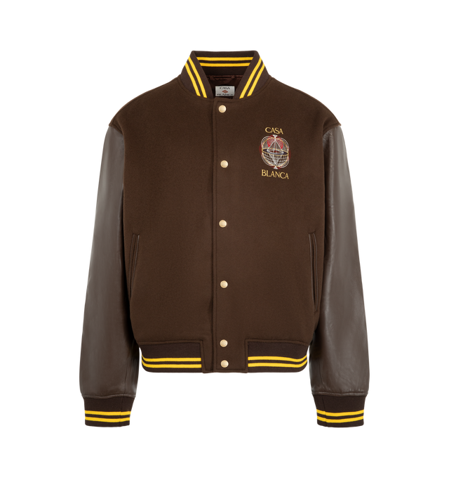 Image 1 of 3 - BROWN - Casablanca Men's Brown Celestial Pyramid Wool & Leather Varsity Jacket is crafted from an Italian wool with lamb nappa leather sleeves and embroidery. Designed in a relaxed silhouette for cold-weather layering, this varsity-inspired jacket is detailed with a button-front closure, branded snap buttons, slanted welt pockets, and classic rib-knit collar, cuffs, and hem finished with yellow stripe accents. Fully lined for comfort, it combines premium materials with Casablanca's distinctiv 