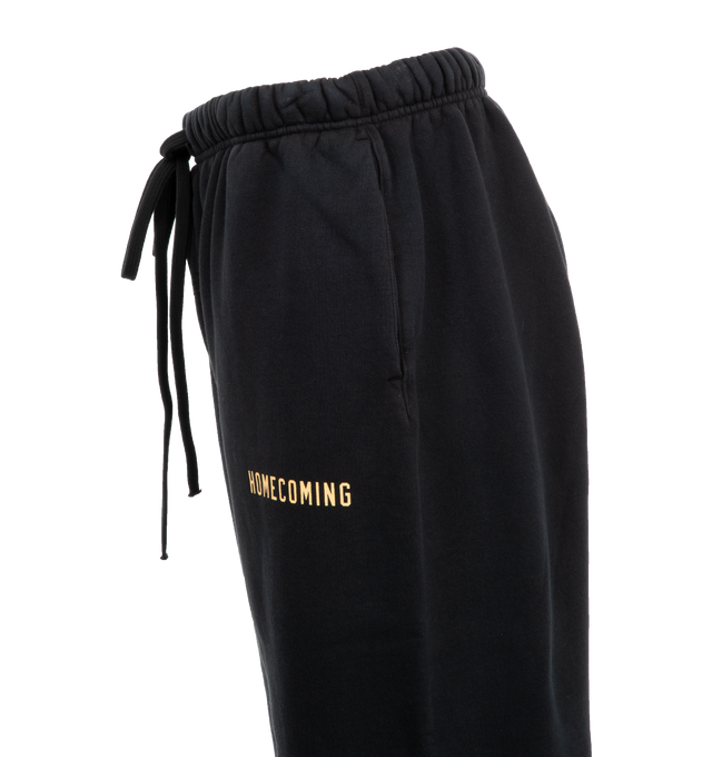 Image 3 of 3 - BLACK - Fear of God Heavy Fleece Sweatpants have an elastic drawstring waist, side seam pockets, elastic hems, and logo details. 83% cotton, 17% recycled polyester fleece.  