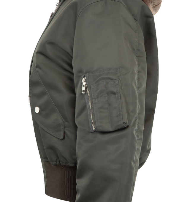 Image 3 of 3 - GREEN - JW ANDERSON Hooded Bomber Jacket featuring distressed brown leather hood, soft short curl ecru sheepskin details, loafer stitch detailing on the hood, a centre front zip with logo leather puller, logo-engraved press snaps and a knitted rib hem. 100% polyamide. Lining: 100% cupro. Made in Italy. 