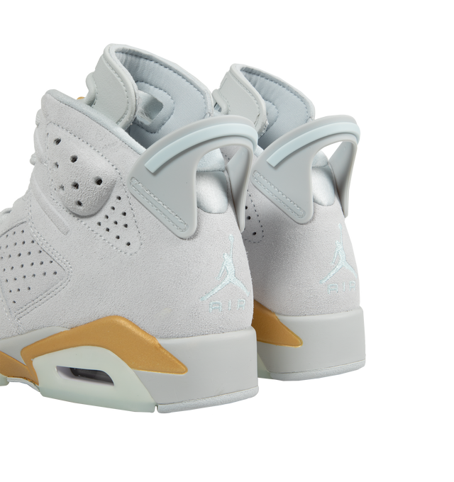 Image 3 of 5 - WHITE - Air Jordan 6 lace-up high top sneaker with a premium suede and textile upper. In celebration of the Paris Olympics, this Retro Pearl pair comes in smooth suede with metallic golden details and pearl lace charms on the laces. Features visible Air units in the forefoot and heel providing ample cushioning and explosive responsiveness. A large tongue with windows protects the top of the foot while providing ventilation. Lace toggle for a locked-in, customized fit. Large heel pull to slip  