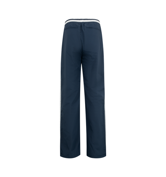 Image 2 of 3 - NAVY - Rhude Champions Track Pants featuring drawstring at elasticized waistband, three-pocket styling, logo printed at front, stripes at outseams and full twill lining. 100% polyester. Made in United States. 