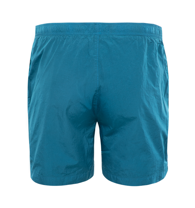 Image 2 of 3 - BLUE - C.P. COMPANY Eco-Chrome R Swim Shorts featuring tonal stitching, two side slash pockets, logo patch to the leg, short side slits, thigh-length, mesh lining and elasticated waistband with internal drawstring. 100% polyamide. 