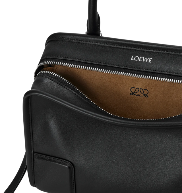 Image 11 of 16 - BLACK - Loewe Small Amazona 180 Bag in leather features a relaxed silhouette anchored by a single toron top handle, designed to be carried open, while a concealed closure secures the main compartment, three carry options: short handle, removable shoulder strap and crossbody, zip closure with two leather zip pullers, two compartments, main compartment closed with magnetic closure, internal flat pocket, left side d-ring for customization, nappa lambskin lining, and embossed double L branding. 