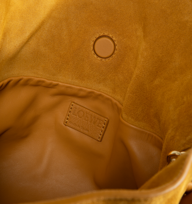 Image 3 of 3 - YELLOW - Loewe Women's Flamenco Medium Clutch is crafted from suede and features the collections signature slouchy silhouette, a cinched closure with iconic knotted drawstrings, and a detachable adjustable strap. Designed to be carried on the shoulder, crossbody, or by hand, this versatile style is finished with a magnetic closure, suede lining, and gold embossed LOEWE branding. Main Material: Suede. Lining: Suede. Dimensions: 30 x 24.5 x 10.5 cm / 11.8 x 9.6 x 4.1 in. Strap Length: 96-120 cm 