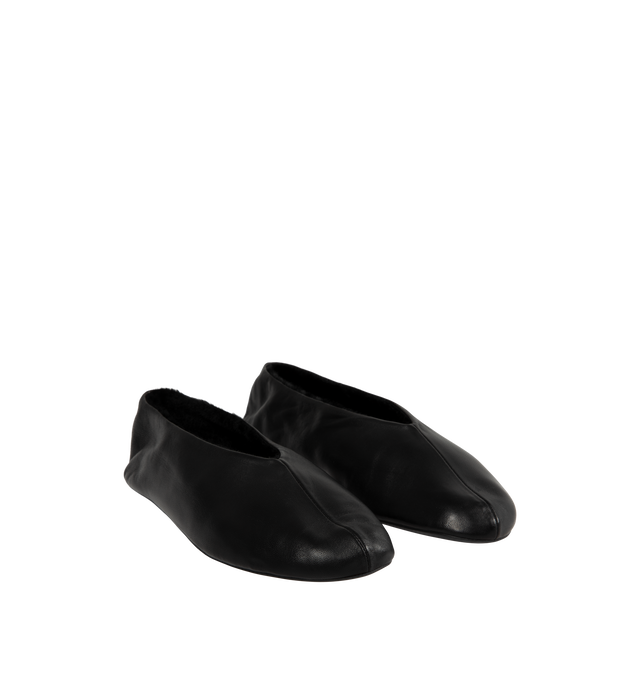 Image 2 of 4 - BLACK - The Row Women's Stella Slippers are crafted from smooth nappa lambskin leather and feature a slip-on silhouette with an oval toe, soft shearling lining, and a flexible rubber-coated sole. These designer leather slippers combine exceptional Italian craftsmanship with luxurious comfort, making them an elevated choice for effortless everyday wear. Main Material: 100% Lambskin Leather. Lining: Shearling. Sole: Rubber-Coated. Made in Italy. 