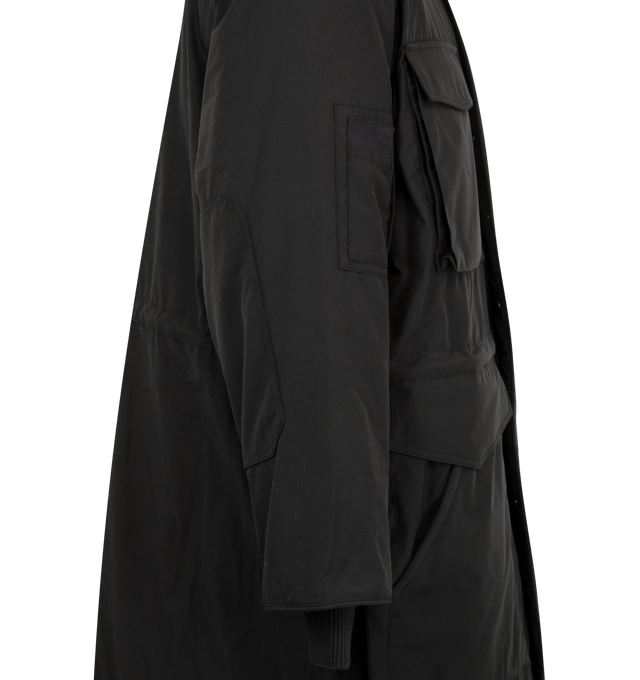 Image 4 of 4 - BLACK - Canada Goose Men's Erie Parka Tonal Disc is crafted from Recycled Organic Arctic Tech and features a heritage-inspired design engineered for extreme cold-weather conditions. Designed with an adjustable hood, fleece chin guard, and an interior drawcord waist, this down-filled parka delivers warmth, protection, and versatility. Functional details include four fleece-lined double-entry pockets, a sleeve pocket, one interior zippered security pocket, two interior drop-in pockets, elbow pa 
