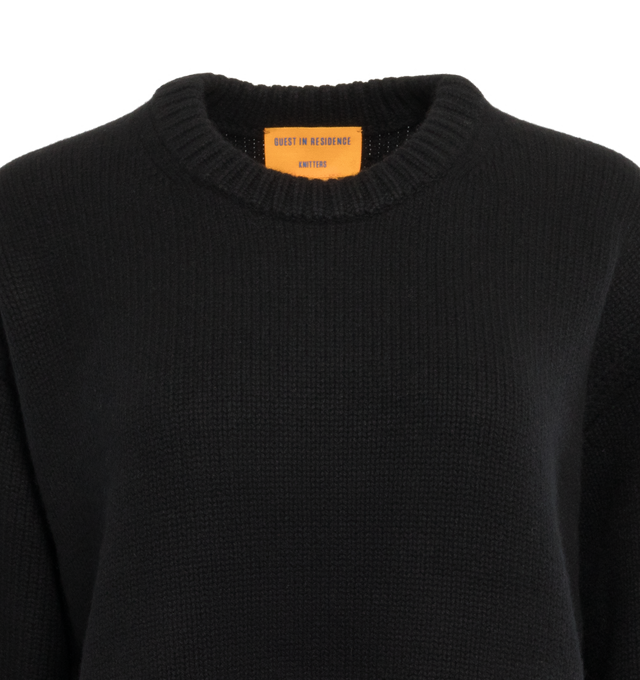 Image 3 of 3 - BLACK - GUEST IN RESIDENCE Cozy Crew featuring oversized fit, crew neck, dropped shoulder, reverse jersey detail around arm & shoulder with tuck stitch, ribbed neck trim, cuff and hem, side slit at hem and jersey cable. 100% cashmere.  