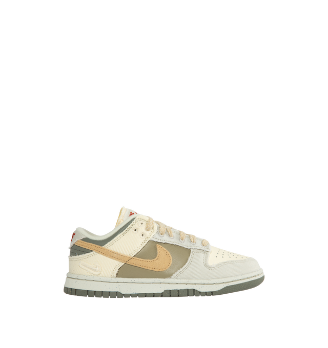 NEUTRAL - NIKE Dunk Low in Light Bone and Dark Stucco featuring lace-up front, signature Swooshes at sides, embossed Air logo at foxing, perforated toe and padded collar with debossed Nike logo at back counter.
