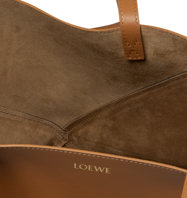 Image 3 of 4 - BROWN - LOEWE Puzzle Fold Medium Tote featuring graphic and architectural panels that allow the bag to fold completely flat, soft, lightweight, shiny nappa calfskin, shoulder or hand carry, suede lining and gold embossed LOEWE. 12.4 x 10 x 5.7 inches. Handle drop: 27 cm. Shiny Calf. Made in Spain. 