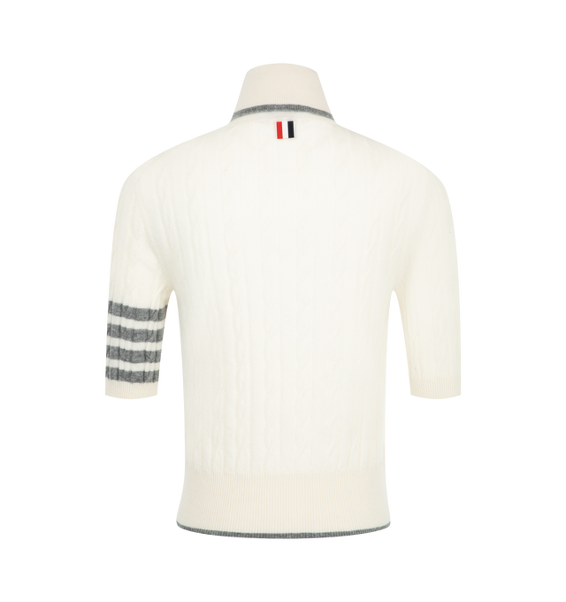 Image 2 of 2 - WHITE - Thom Browne Women's Cashmere 4-Bar Baby Cable Stitch Turtleneck is crafted from luxurious cashmere and features a delicate baby cable stitch construction accented by the brands signature engineered 4-bar detail. Designed with a ribbed foldover turtleneck and hem with contrast tipping, the knit is finished with ribbed cuffs, buttoned side vents with internal RWB grosgrain trim, and Thom Brownes signature striped grosgrain loop tab. Main Material: 100% Cashmere. Made in Italy. 