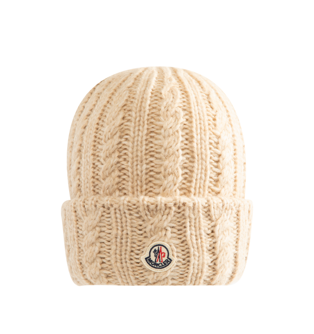 Image 1 of 2 - NEUTRAL - Moncler Women's Cable Knit Wool Blend Beanie is crafted from a wool, nylon, and alpaca blend and features a textured cable-knit construction with ribbed-knit detailing. Designed as a timeless cold-weather accessory, the beanie is finished with the signature Moncler logo patch at the front. Main Material: 43% Alpaca, 36% Polyamide, 21% Wool. Cable-Knit and Ribbed-Knit Construction. Logo Patch. Made in Italy. 