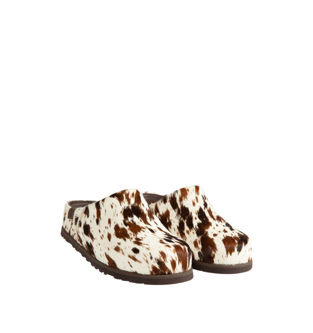 Image 2 of 4 - BROWN - Ugg Men's Otzo Western Clog is crafted with a hand-painted cow hair upper and reimagines the brands signature clog silhouette through a Western-inspired lens. Designed for all-day comfort, this distinctive style features a leather and RWS wool jersey lining enhanced with a peppermint-based anti-odor treatment, along with a contoured EVA footbed for cushioning and support. A leather and microfiber sockliner provides additional comfort, while the lightweight rubber outsole with 30% FCS- 