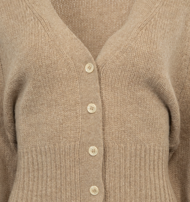 BROWN - DEIJI STUDIOS The Cropped Cardigan featuring rib knit Y-neck, cropped hem, and cuffs, button closure and raglan sleeves. 80% wool, 20% recycled nylon. Made in China.