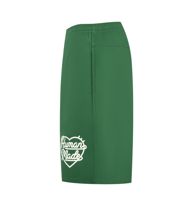 Image 3 of 3 - GREEN - HUMAN MADE Beach Shorts featuring shiny, firm cotton twill fabric, iconic heart logo on the front left hem, pockets on both sides and the right hip and waist cord with the brand logo. 100% cotton.  