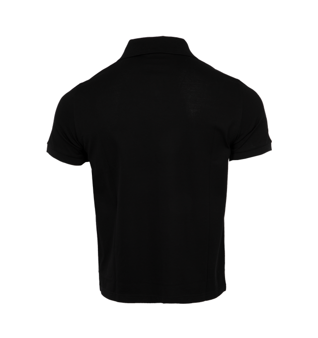 BLACK - SAINT LAURENT Polo Shirt featuring tonal embroidered cassandre on the chest, three button placket at the neck, flat knit polo collar and cuffs. 100% cotton. Made in Italy.