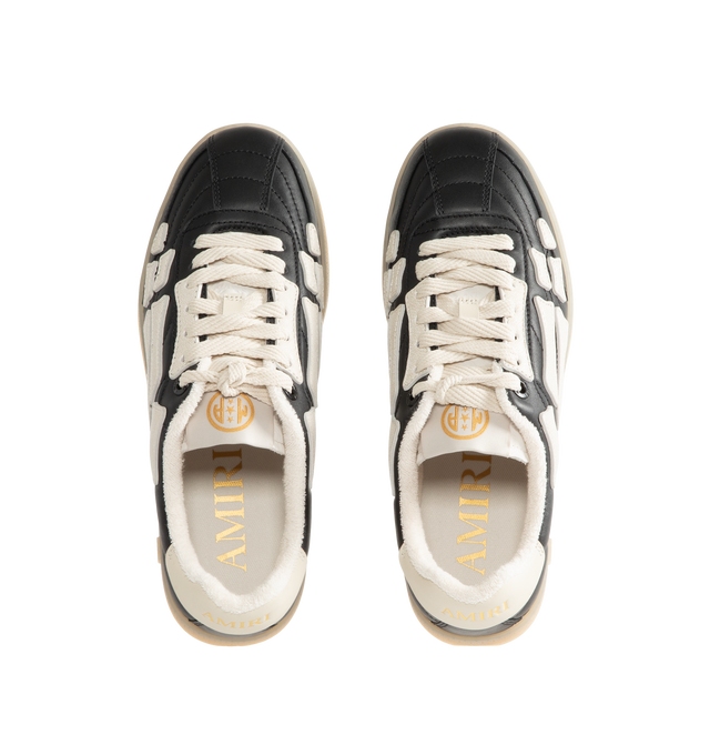 Image 5 of 5 - BLACK - Amiri Mens Pacific Football Sneakers are crafted with a leather upper and signature pebbled leather bone appliqus. Feature contrast topstitching, lace-up closure, padded collar, two-tone rubber sole, and low-top silhouette. Main Material: Leather Upper; Sole: Rubber. Made in Vietnam. 