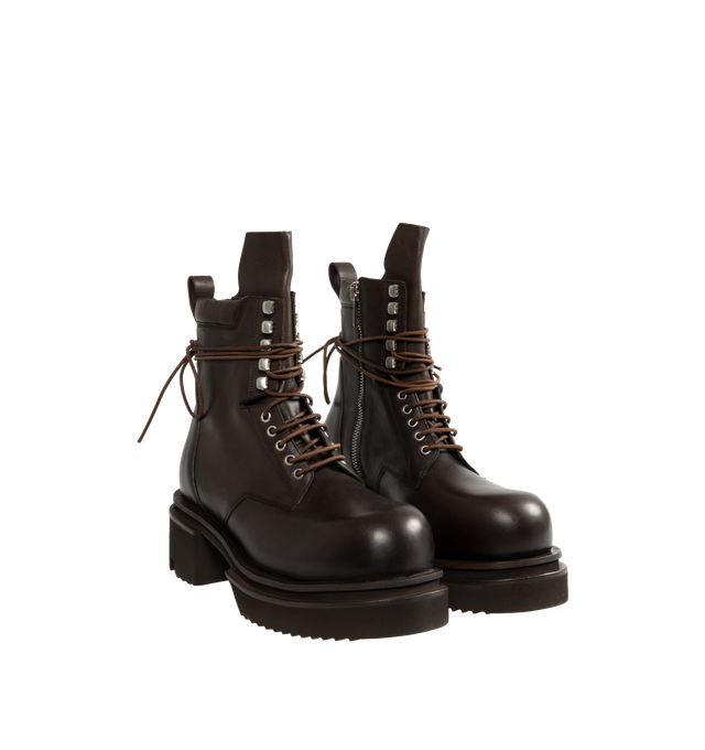 Image 2 of 4 - BROWN - Rick Owens Men's Laceup Bogun Boots are crafted from washed calf leather and feature a mid-calf silhouette with long wraparound laces, a rounded toe, and the brand's signature Bogun rubber mega creeper sole. Designed with eyelets and hooks, angled topstitched panels, an inner-leg zip closure, a back pull tab, and a toothed square heel for a bold, architectural look. Main Material: 100% Calf Leather. Lining: 100% Calf Leather. Insole: 100% Calf Leather. Intersole: 100% Cow Leather. Sol 
