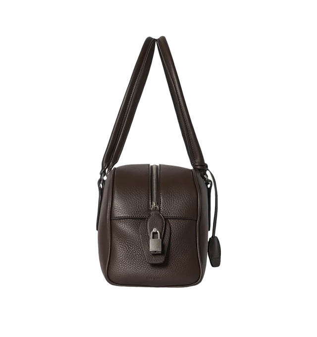 Image 3 of 3 - BROWN - THE ROW E/W India Bag featuring bowling bag in textured calfskin leather with elongated silhouette, extended tubular handles, piping, branded metal padlock and key and top zipper closure. 13.4 x 6.7 x 5.3 in. Antique silver hardware finishing. 100% calfskin leather. Lined in 100% lambskin leather. Made in Italy.  