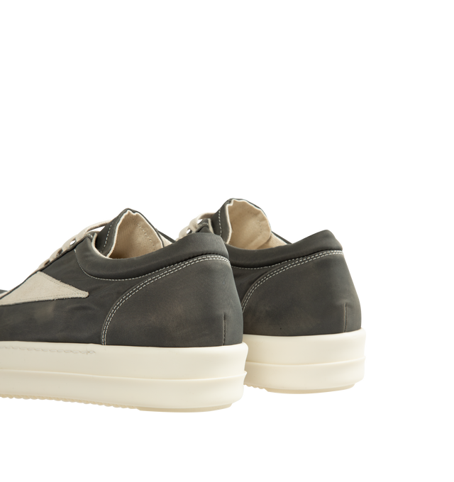 Image 3 of 5 - GREY - Rick Owens DRKSHDW Vintage Sneaks are designed with a low-top design including a lace-up closure, signature shark-tooth soles, and contrast stitching. The medium-weight denim is overdyed for a soft, washed handfeel, while the fabric undergoes responsible treatment processes designed to reduce water consumption. Upper: 100% Cotton. Lateral Details: 100% Calf Leather. Lining: 100% Cotton. Sole: 100% Thermoplastic Rubber. Sole Height: 3.5 cm / 1.4 in. Closure: Lace-Up. Made in Italy. 