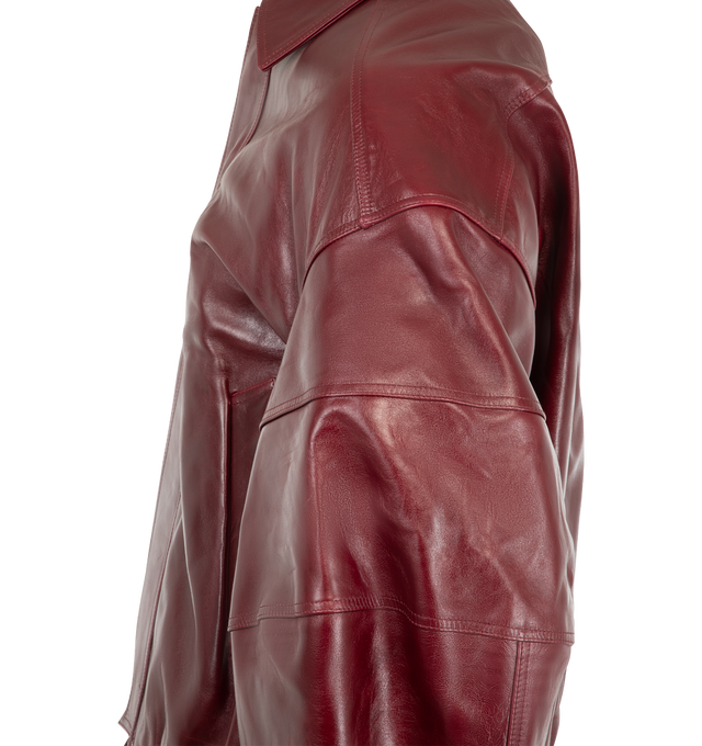 Image 4 of 4 - RED - Willy Chavarria Men's OS Hustler's Leather Jacket is crafted from lambskin leather and features an oversized silhouette, sculptural paneled sleeves, a matching leather belt at the hem, and a concealed front zip closure. Designed with oversized welt pockets, ribbed cuffs, and clean construction, this leather bomber balances volume with refined tailoring. Main Material: 100% Lambskin. Lining: 100% Cotton. 