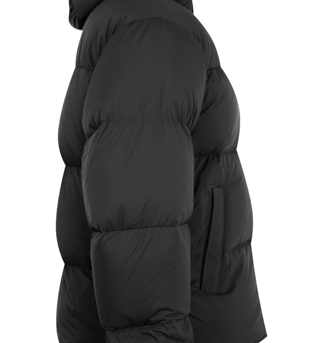 Image 3 of 3 - BLACK - Canada Goose Men's Sterling Puffer Coat is crafted from lightweight plain-weave poly fabric with a smooth matte finish and features a regular-fit silhouette with wide quilted baffles. Designed for cold-weather protection, this down-filled coat is finished with a fixed hood with hidden cord lock, a concealed snap placket over a two-way zip closure, an exposed bottom snap, elasticized cuffs, and an adjustable drawcord hem. Functional storage includes two exterior zippered welt pockets,  