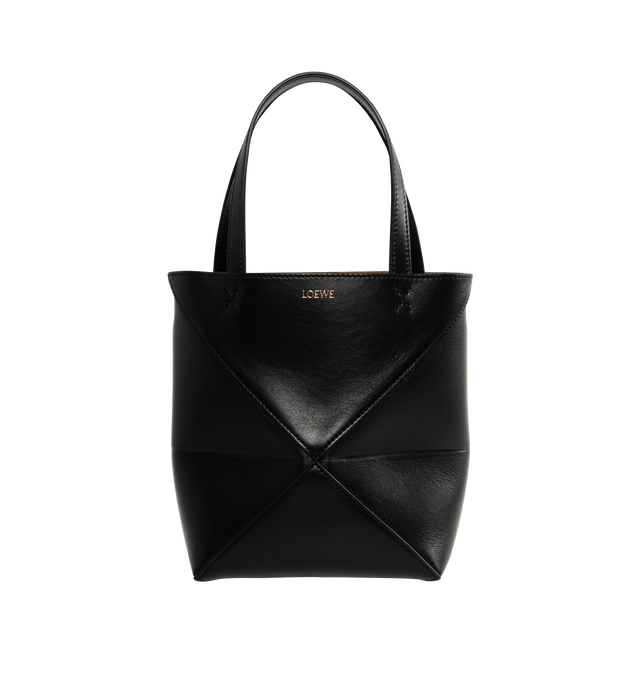 BLACK - LOEWE Mini Puzzle Fold Tote in shiny calfskin takes the iconic bags signature geometric lines and reimagines them in graphic and architectural panels that allow the bag to fold completely flat, making it the perfect travel companion. Soft, lightweight and inventively crafted, it is finished with discreet LOEWE branding. Features shoulder, crossbody or hand carry, detachable and adjustable strap, suede lining and gold embossed LOEWE. Measures 7.9" high X 6.5" wide X 3.7" deep with a 5.5" handle d