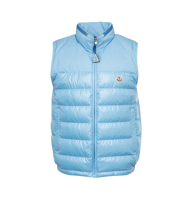 Image 1 of 3 - BLUE - MONCLER Cerces Down Vest featuring stowaway hood at stand collar, two-way zip closure, felted logo patch at chest, zip pockets, elasticized hem, zip pocket at interior, fully lined and logo-engraved silver-tone hardware. 100% polyester. Fill: 90% duck down, 10% feathers. 