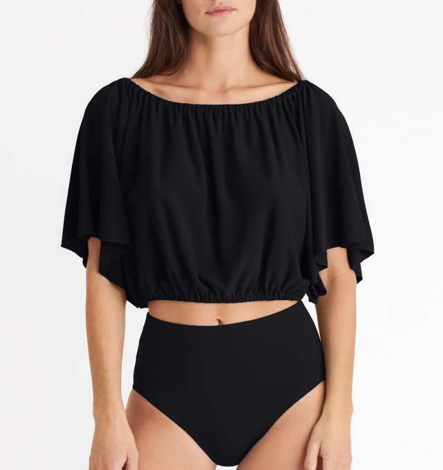 Image 3 of 5 - BLACK - ERES Solal Crop Top featuring elasticated neckline and waist with short butterfly sleeves. 94% Polyamid, 6% Spandex. Made in France. 
