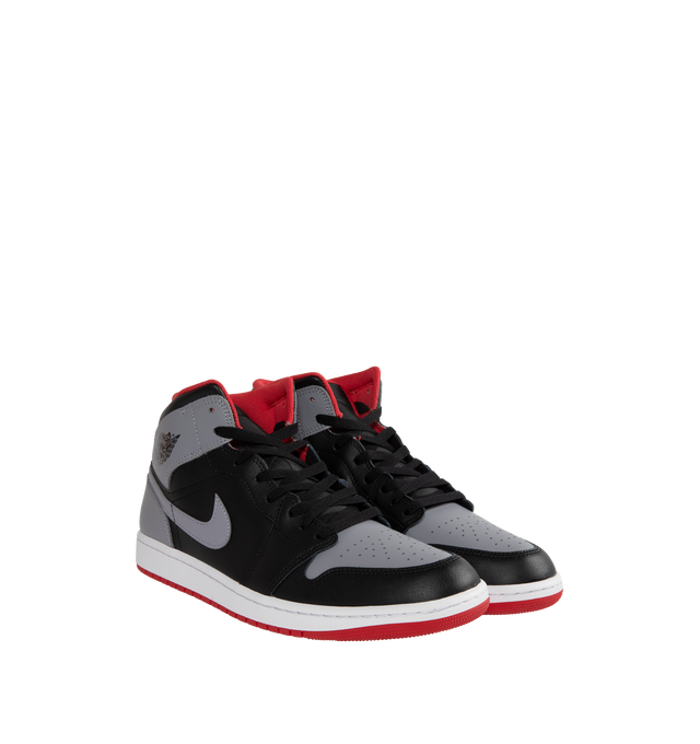 Image 2 of 5 - MULTI - AIR JORDAN 1 MID are grey, black and red sneakers made from a premium leather and synthetic upper which provides durability, comfort and support. These sneakers have an air-sole unit in the heel that delivers signature cushioning as well as has a rubber outsole that offers traction on a variety of surfaces. 