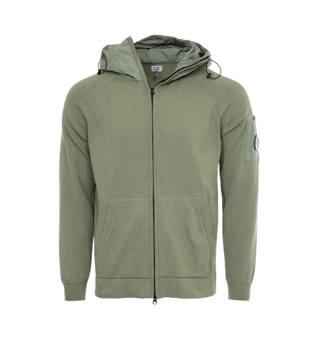 GREEN - C.P. COMPANY Cotton Mixed Hooded Knit featuring stand-up collar, adjustable hood, full zip fastening, lens detail, kangaroo pockets, ribbed cuffs, 7 gauge knit thickness and regular fit. 100% cotton.