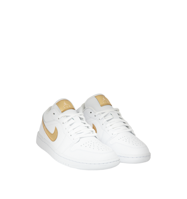 Image 2 of 5 - GOLD - Women's Air Jordan 1 Low SE Sneakers feature a genuine leather upper with signature stitched overlays, a low-top silhouette, and iconic Wings branding for a timeless look. These lifestyle sneakers combine lightweight Air-Sole cushioning, a supportive cupsole construction, and a durable rubber outsole for everyday comfort, stability, and reliable traction. Main Material: Genuine Leather. Midsole: Foam with Air-Sole Unit. Sole: Rubber. 