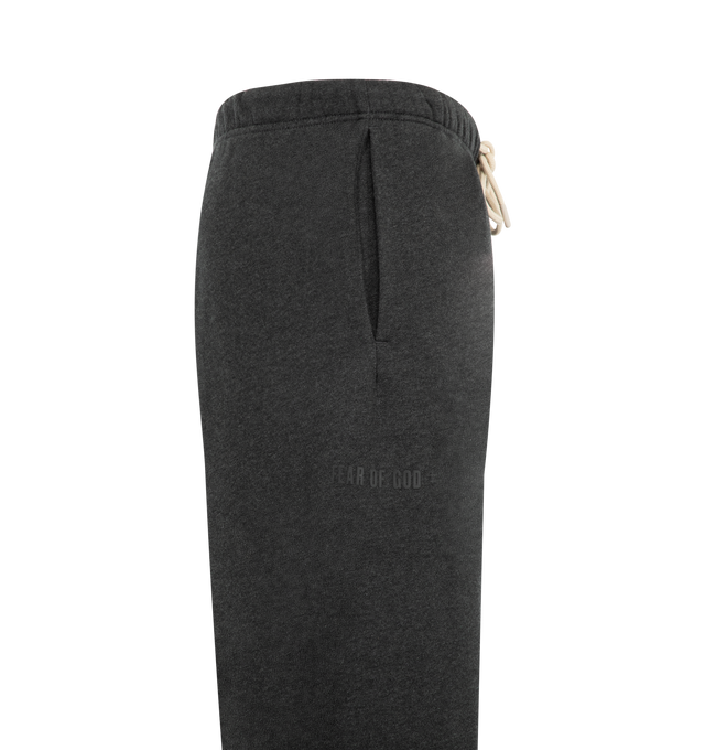 Image 3 of 3 - GREY - Fear of God Essentials Mens Classic Sweatpants are crafted from heavyweight 380 GSM cotton-blend core fleece. Feature a classic relaxed fit with tapered legs, elasticized waistband with bungee drawcord, side-seam pockets, elastic ankle cuffs, puff-printed Fear of God and Essentials branding, and an Essentials logo label. Main Material: 80% Cotton, 20% Polyester.  
