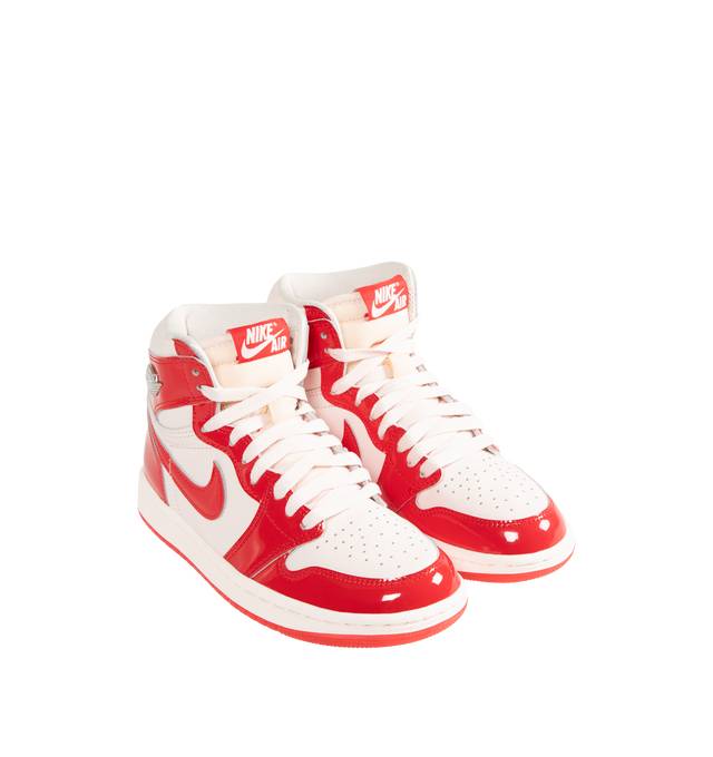 Image 2 of 5 - RED - Jordan Women's Air Jordan 1 Retro High OG "Nails and Grails" Sneakers feature a premium leather upper with glossy University Red patent leather overlays and Light Soft Pink, white, and Metallic Silver accents. Classic Nike Air tongue branding, metal Jumpman and Wings logos, a perforated toe, and a high collar define the design, while a foam midsole with Nike Air cushioning and a rubber outsole complete the construction. Upper: Premium Leather and Patent Leather. Midsole: Foam. Sole: R 