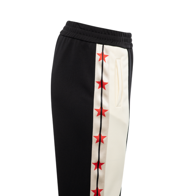 Image 3 of 3 - BLACK - PALM ANGELS Moneygram Haas F1 Team Track Pants featuring elastic waistband, monogram patch on front, colorblocking and stars down leg. 100% polyester.  