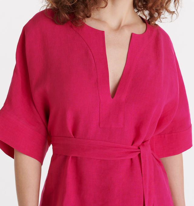 Image 4 of 4 -  PINK - ERES Bibi Kaftan featuring short sleeves, V-neckline, pleated back, removable belt without loop, rounded slits on each side at the bottom and length above ankles. 100% Linen. Made in Bulgaria. 