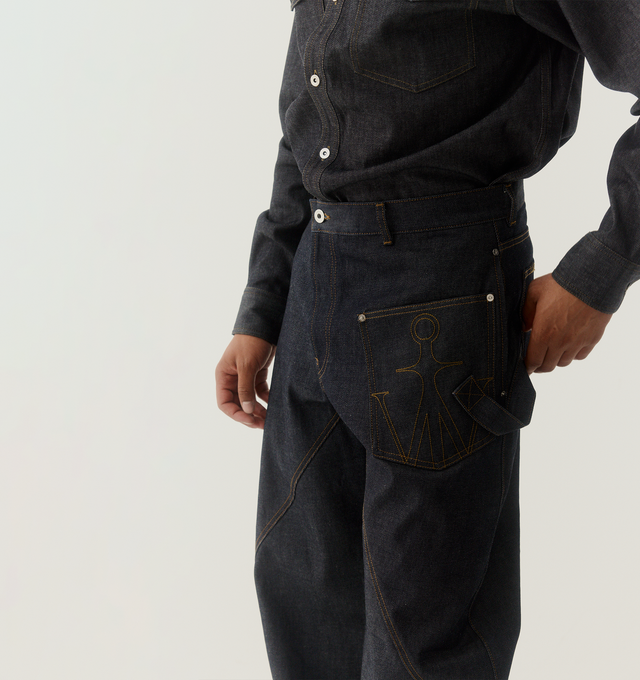 Image 2 of 5 - BLUE - JW ANDERSON Twisted Workwear Jeans featuring a workwear silhouette, diagonal seams at the legs, a patch pocket at the side, belt loops, side patch pocket, back patch pocket and zip fly with button closure. 100% cotton. Made in Italy. 